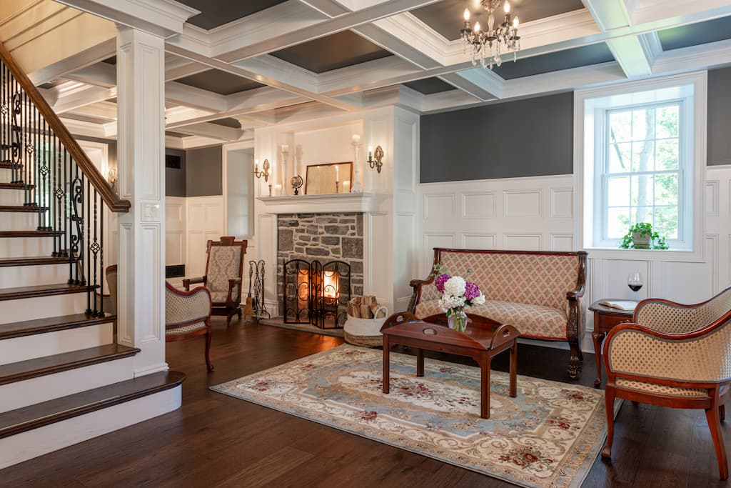 A cozy living room featuring a fireplace and a staircase leading to an upper level.